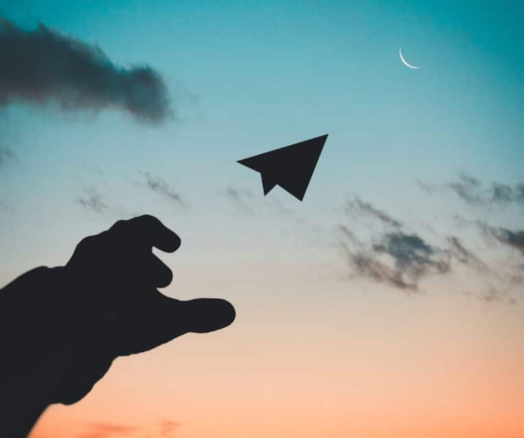 person throwing paper plan into the air