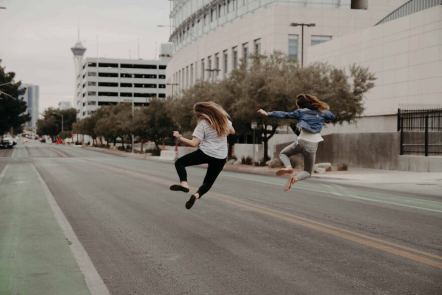 two ladies jumping for joy at being free of alcohol