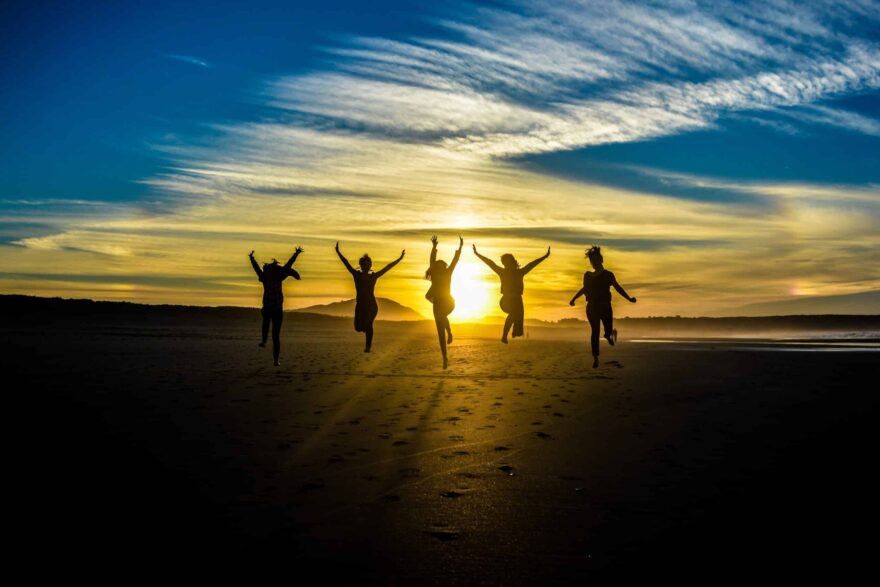five people jumping for joy