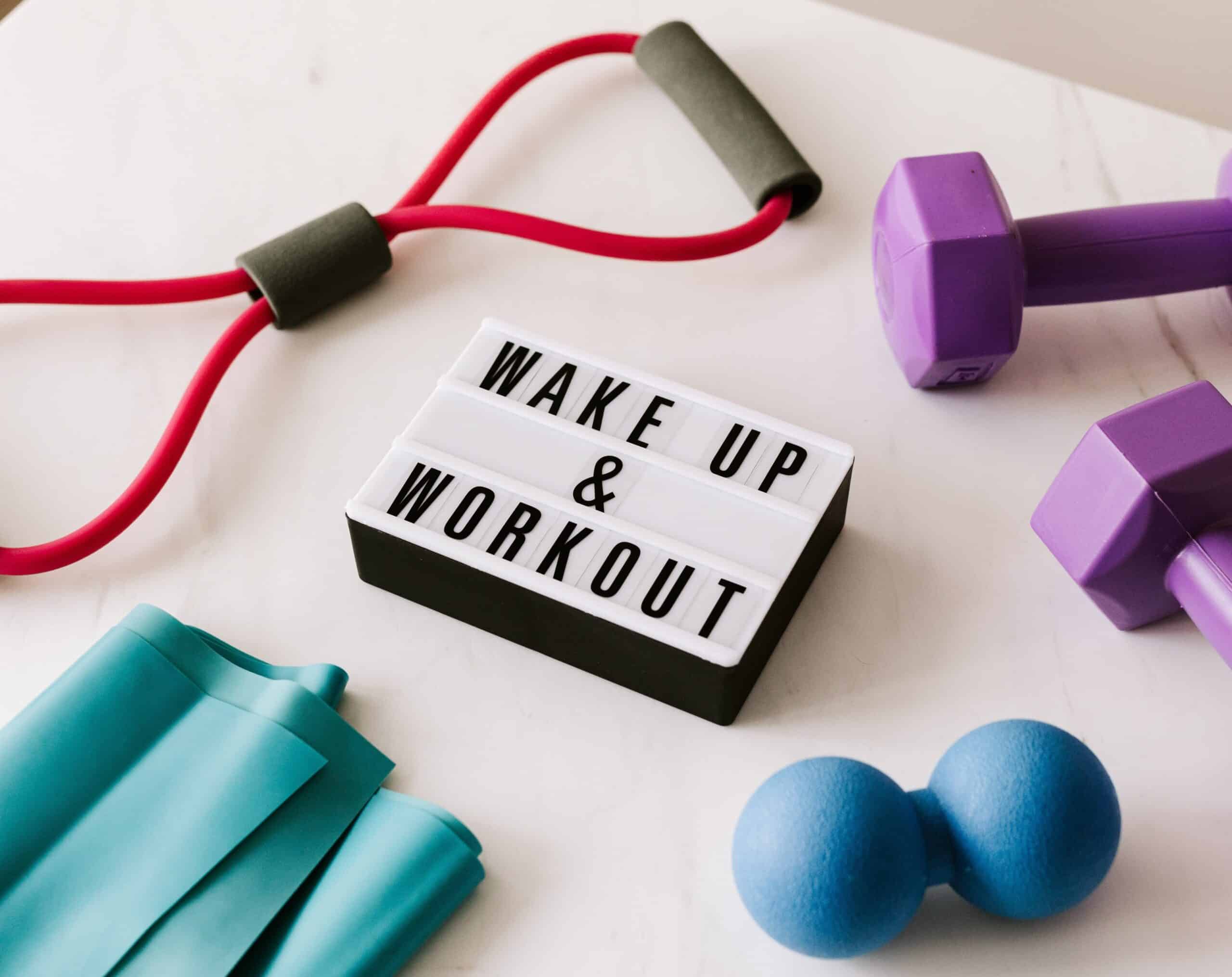 wake up and workout sign and exercise equipment