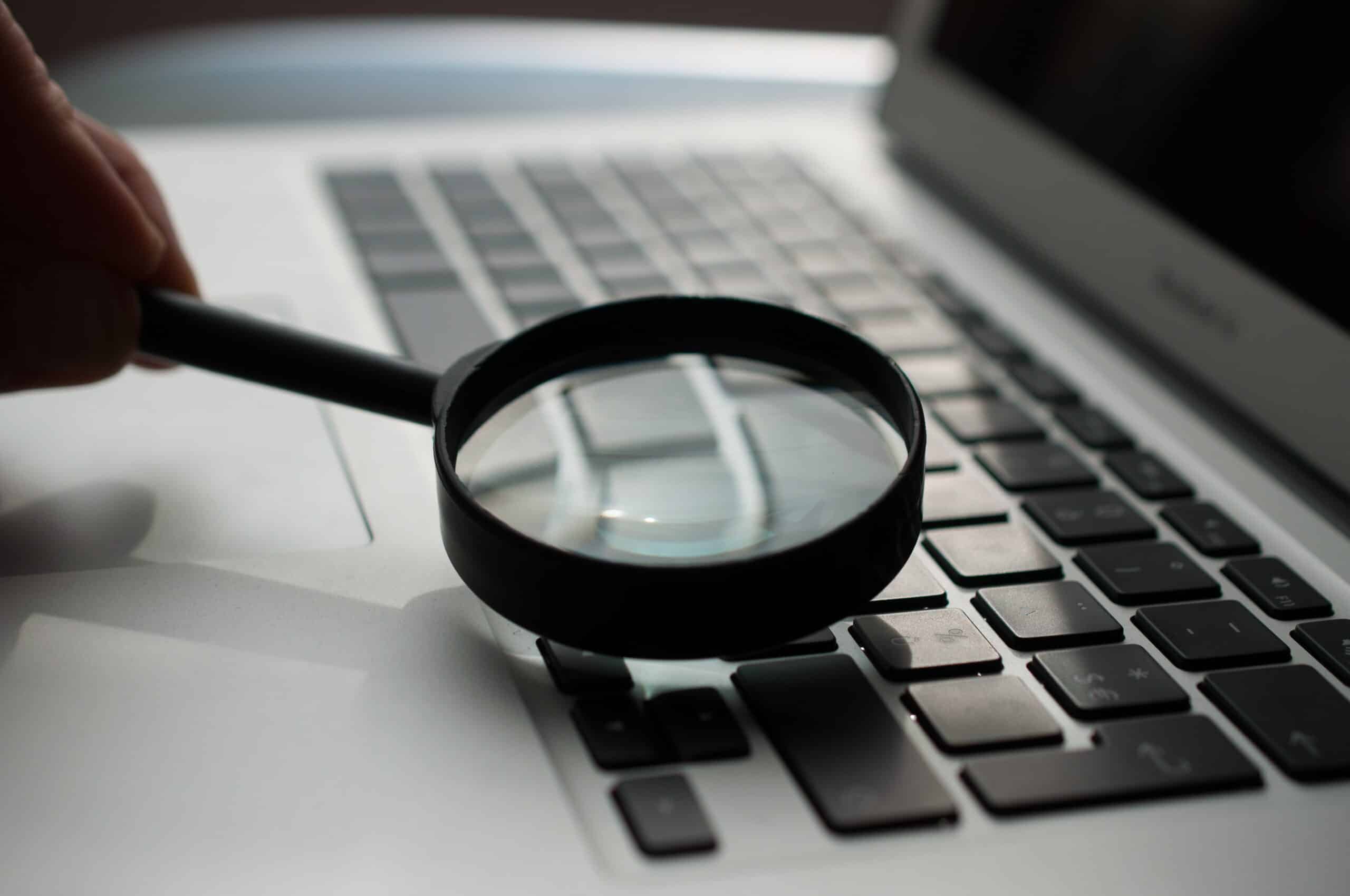 person holding magnifying glass looking for facts