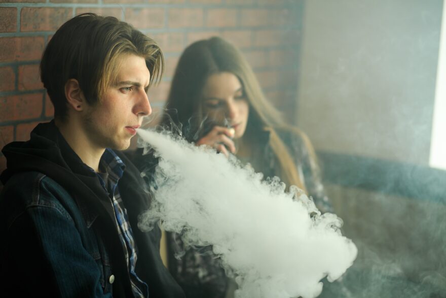 two teenagers vaping